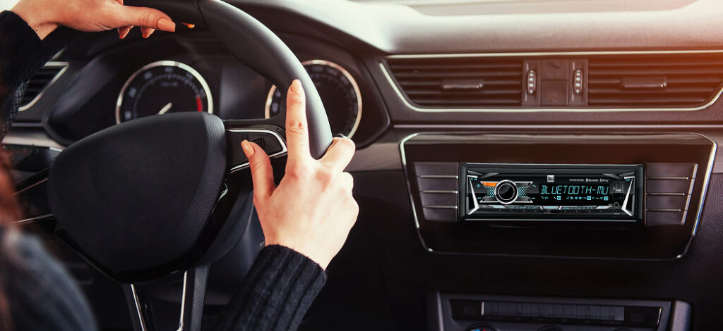 XRM69RGB car stereo mounted in dash with woman driving