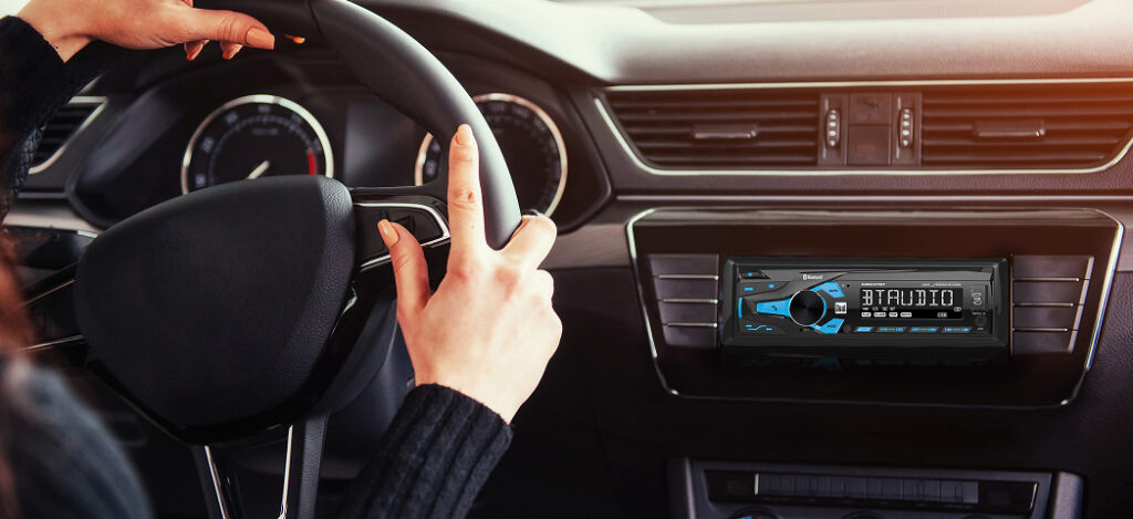 XRM47BT car stereo mounted in dash with woman driving