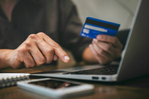 person entering credit card information on a computer