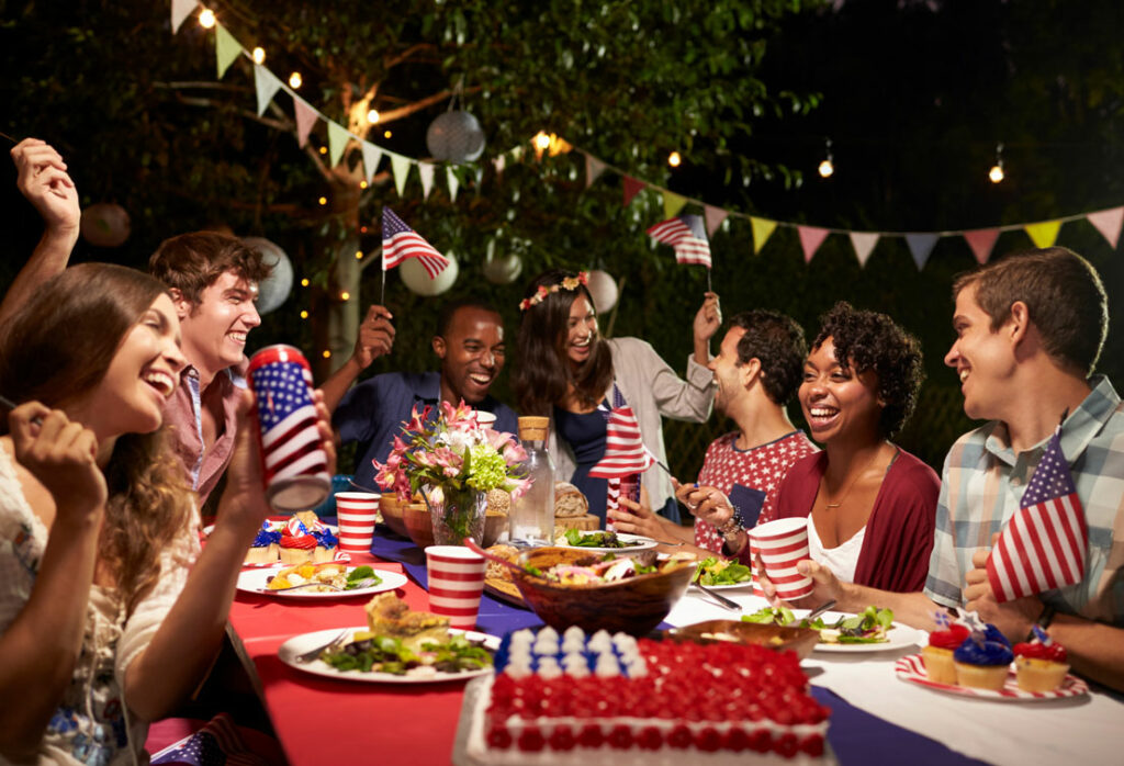 friends sitting at outdoor table for a 4th of july party