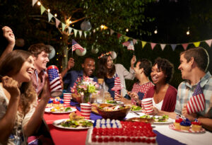 friends sitting at outdoor table for a 4th of july party