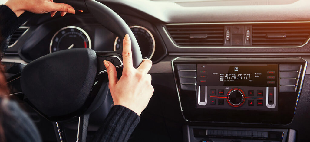 XD28BT car stereo mounted in dash with woman driving