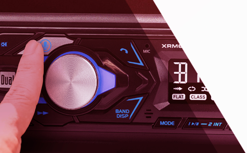 finger pushing the push to talk button on a car radio