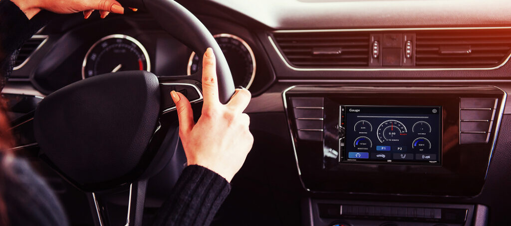 DMCPA7MW installed in car showing car stereo mounted in dash with woman driving
